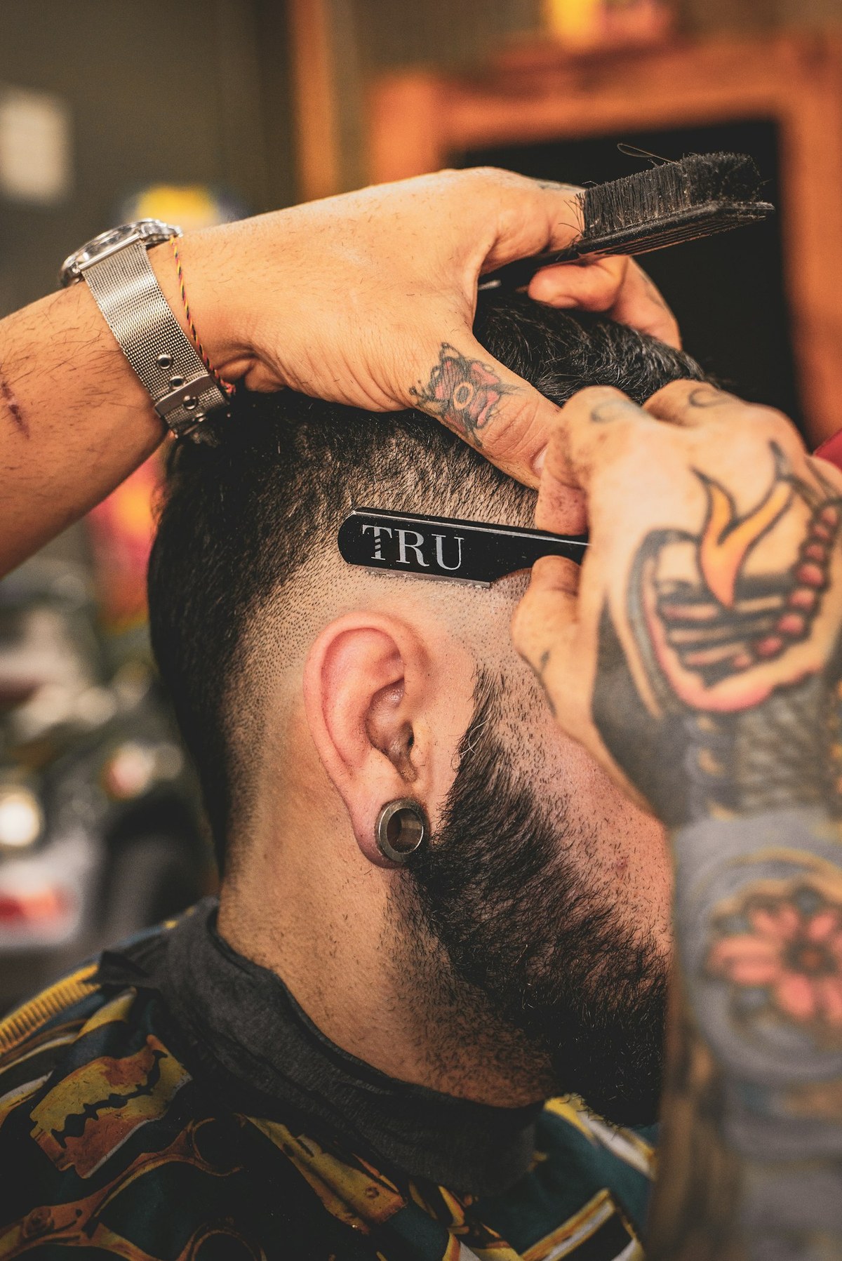 Illustrative barber at work with a straight razor — not a photo of The Legend’s Barber